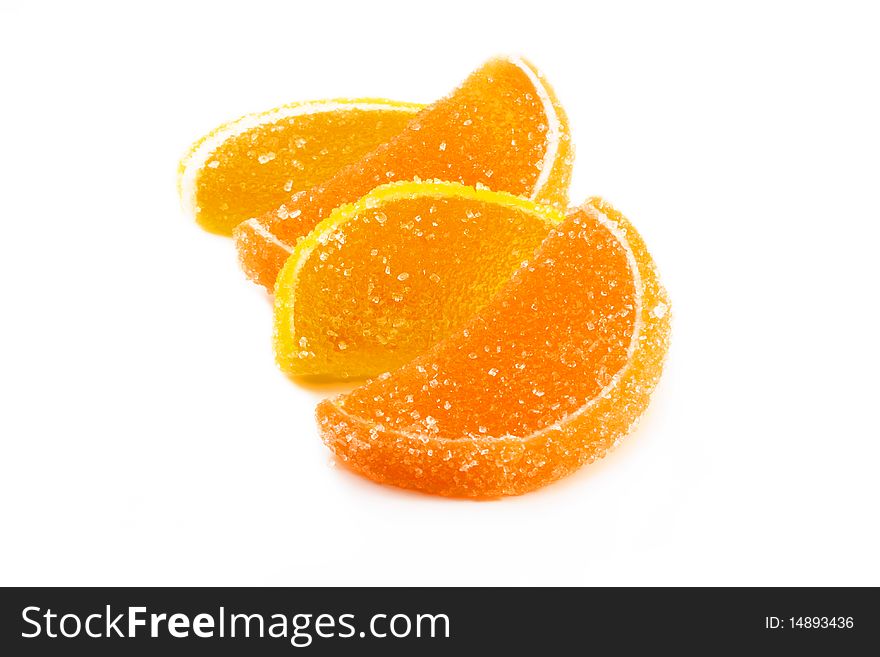 Slices of orange and lemon marmalade on a white background. Slices of orange and lemon marmalade on a white background