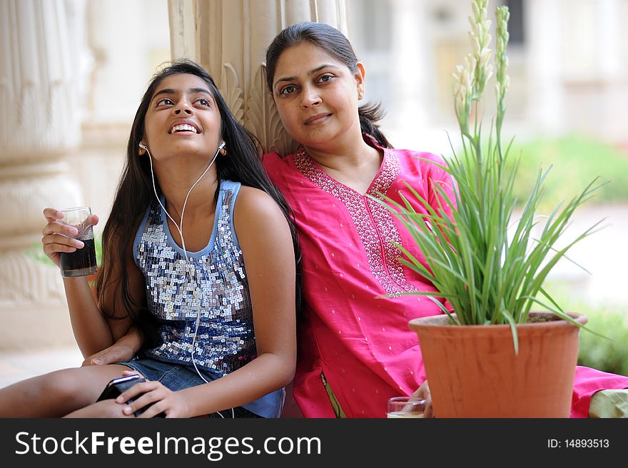 Happy mother and daughter listening music. Happy mother and daughter listening music