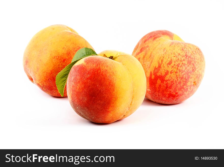 Ripe Peach With A Leaf On A White Background