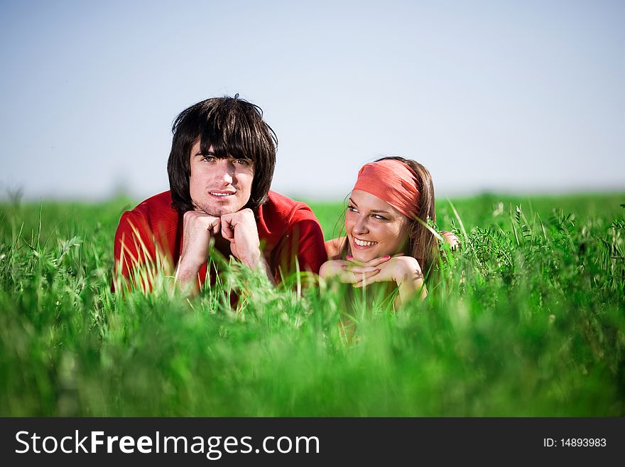 Boy and smiling girl in kerchief on grass. Boy and smiling girl in kerchief on grass