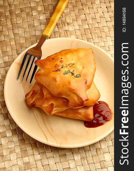 Vegetable  puff with tomato ketchup on a mat background. Vegetable  puff with tomato ketchup on a mat background