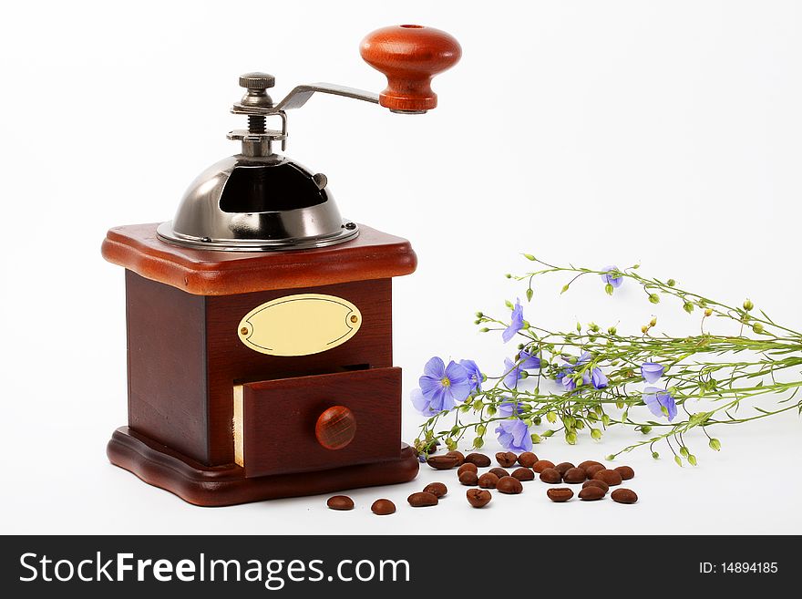 Manual coffee grinder with colours and grains Ð¶Ð°Ñ€ÐµÐ½Ð½Ð¾Ð³Ð¾ coffee on a white background. Manual coffee grinder with colours and grains Ð¶Ð°Ñ€ÐµÐ½Ð½Ð¾Ð³Ð¾ coffee on a white background