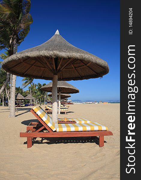 chairs and umbrella on tropical beach.SanYa.china. chairs and umbrella on tropical beach.SanYa.china