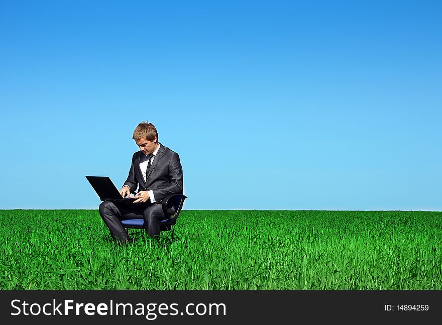 Successful man on the field with laptop. Successful man on the field with laptop