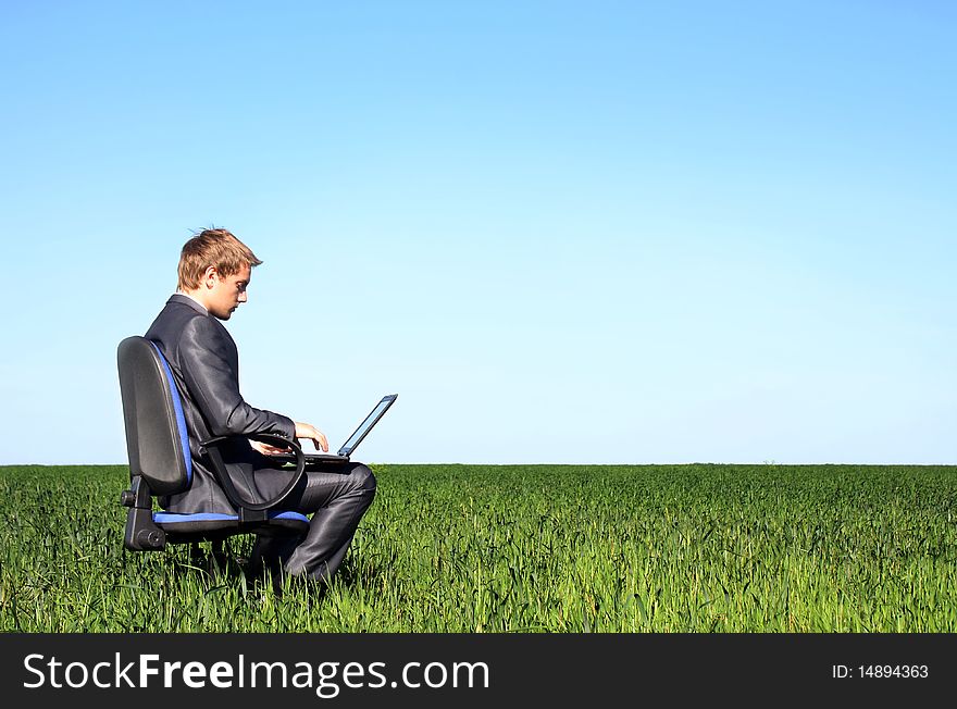 Successful Businessman, In The Field With Laptop