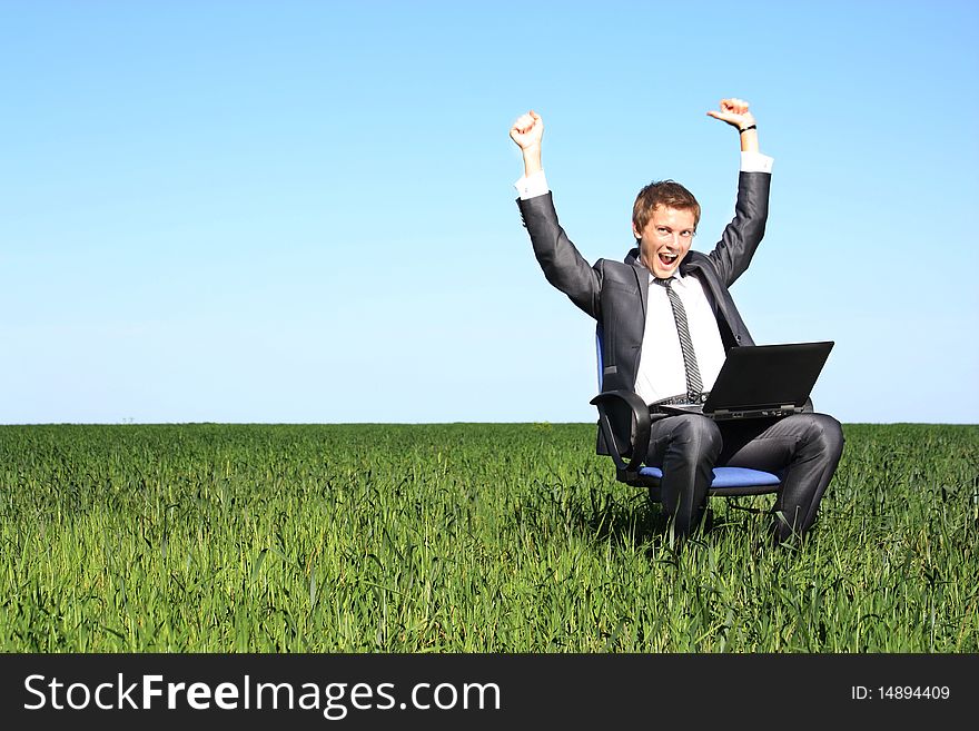 Happy successful businessman.Happy on the green field. Happy successful businessman.Happy on the green field