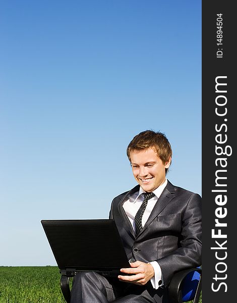 Businessman in the field, with a laptop. Happy, successful. Businessman in the field, with a laptop. Happy, successful