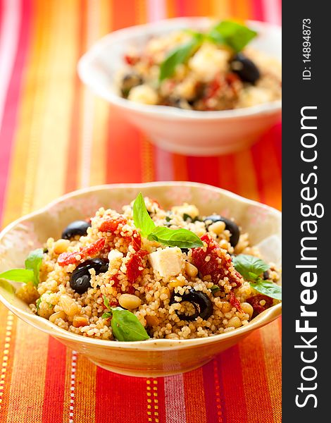 Mediterranean couscous salad with dried tomatoes,feta,olives and basil