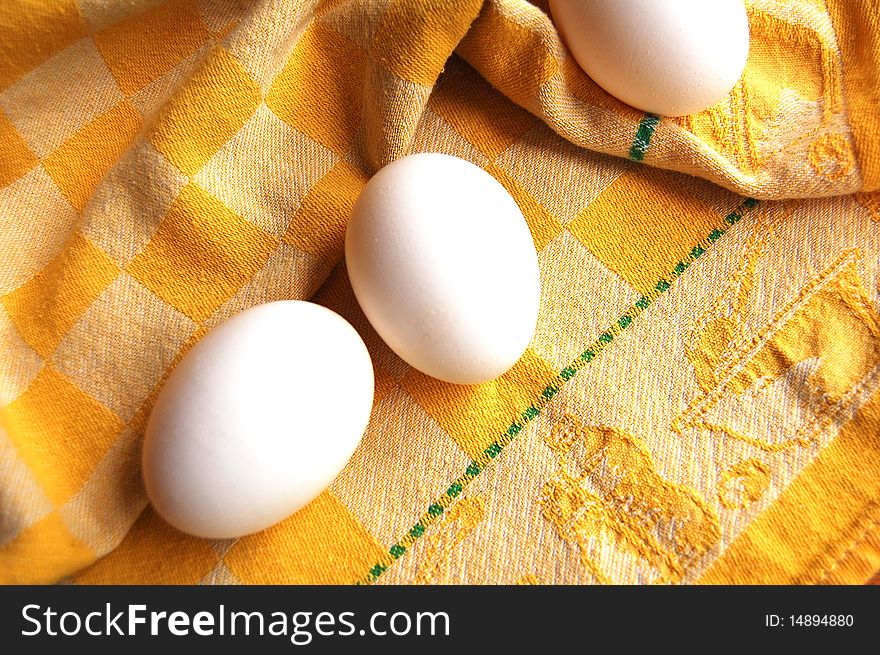 3 eggs on yellow dish towel