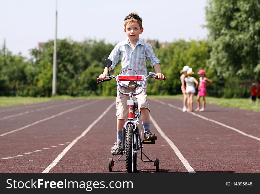 Little boy goes for a drive on a bicycle
