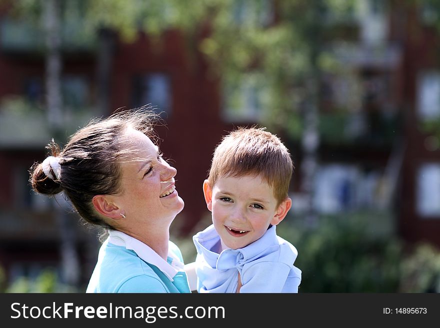 Happy mother and her little son outdoors session