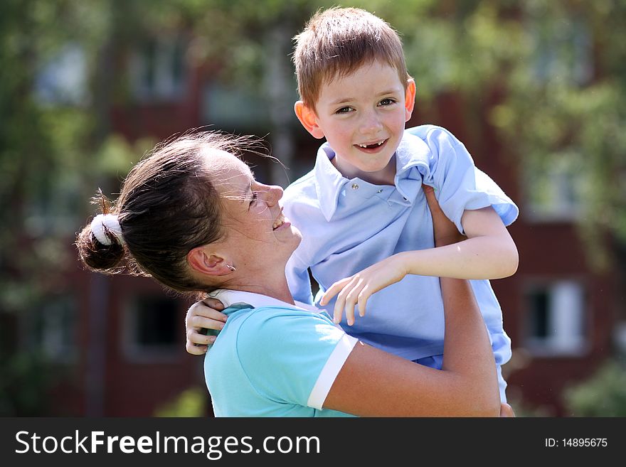 Happy mother and her little son outdoors session