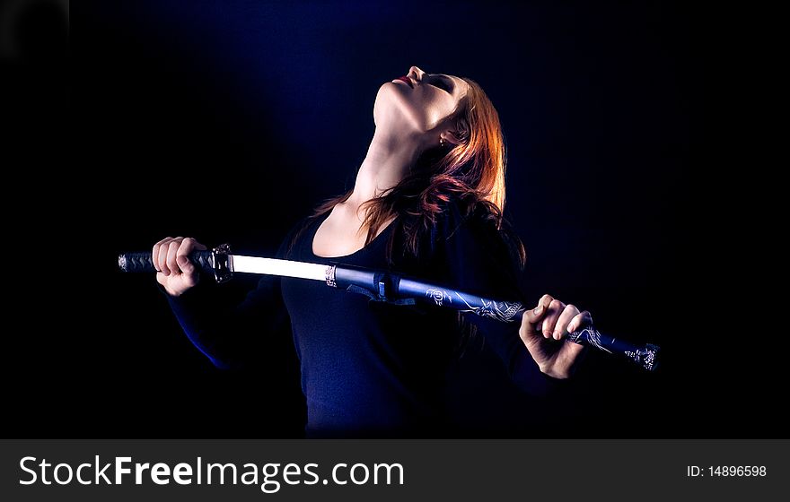 A young lady with a sword on a black background