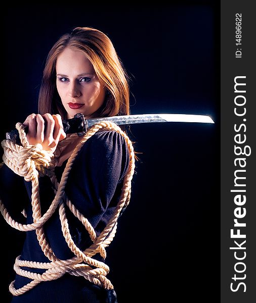 A young lady with a sword on a black background
