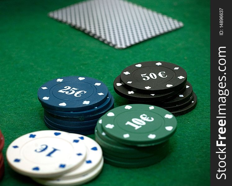 Cards and poker chips on a green  background