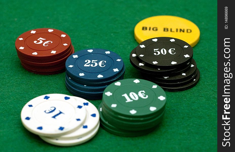 Cards and poker chips on a green  background