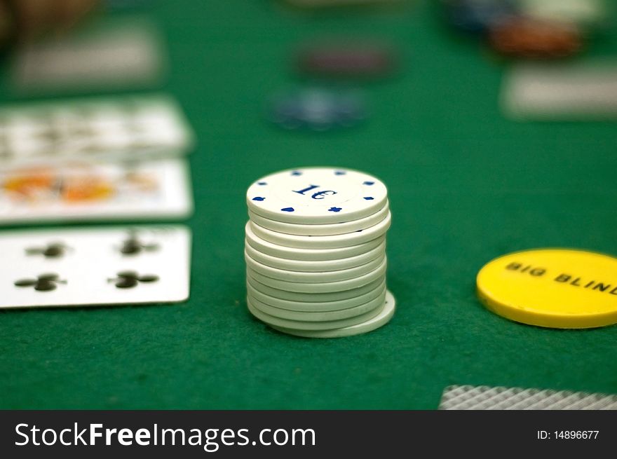 Cards and poker chips on a green  background