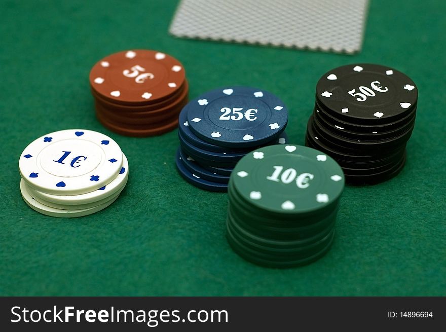 Cards and poker chips on a green background