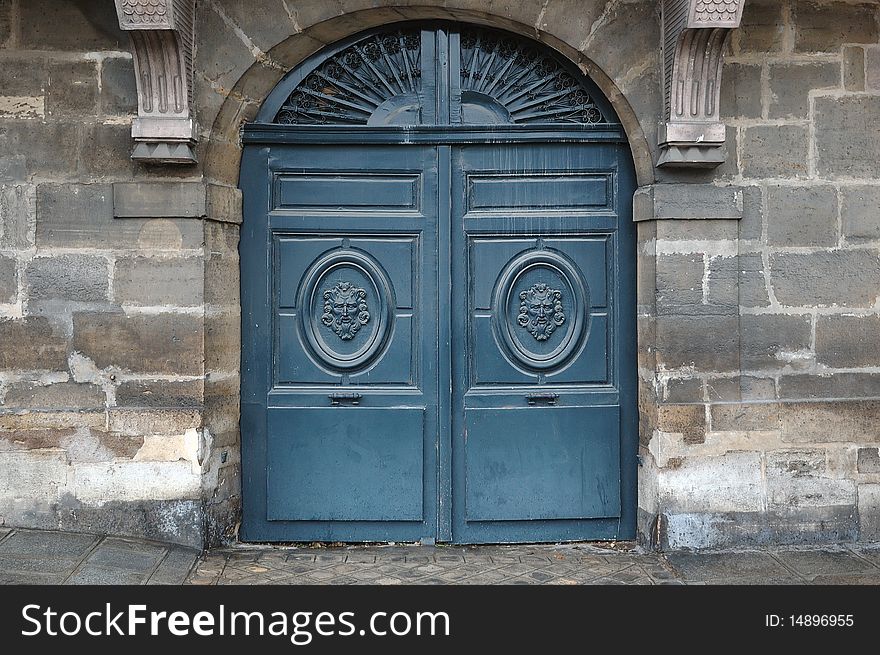 Old wooden door with metal and wooden ornaments