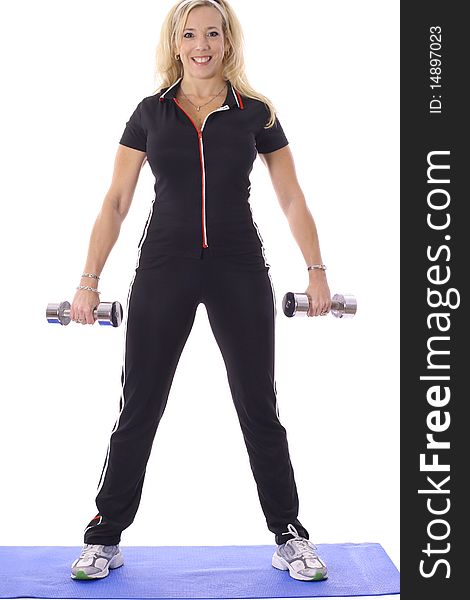 Shot of woman lifting weights on floor mat