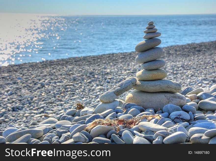 Stone pyramid on the beach in Black Sea