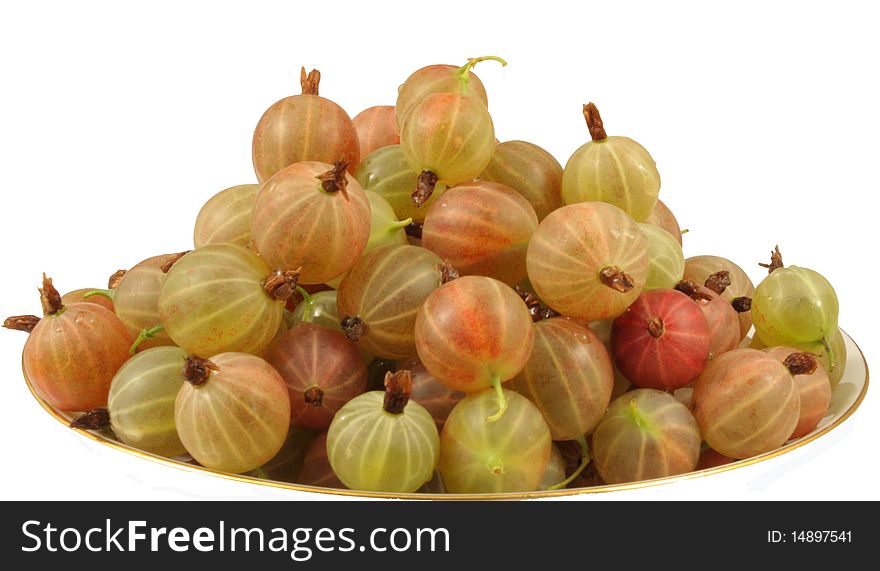 Sweet ripe gooseberry is a saucer, gooseberries with drops of water on a white background