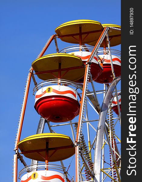 Colorful ferris wheel with blue sky background