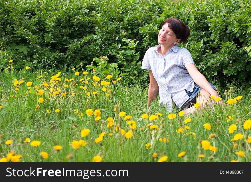 Young girl relaxing on a meadow dandelion. Young girl relaxing on a meadow dandelion