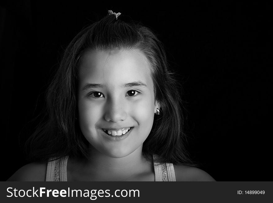 Girl smiling and looking at the camera. Black and white image
