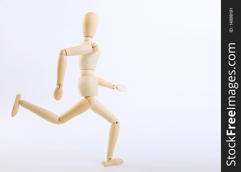 Wooden doll running on a white background.