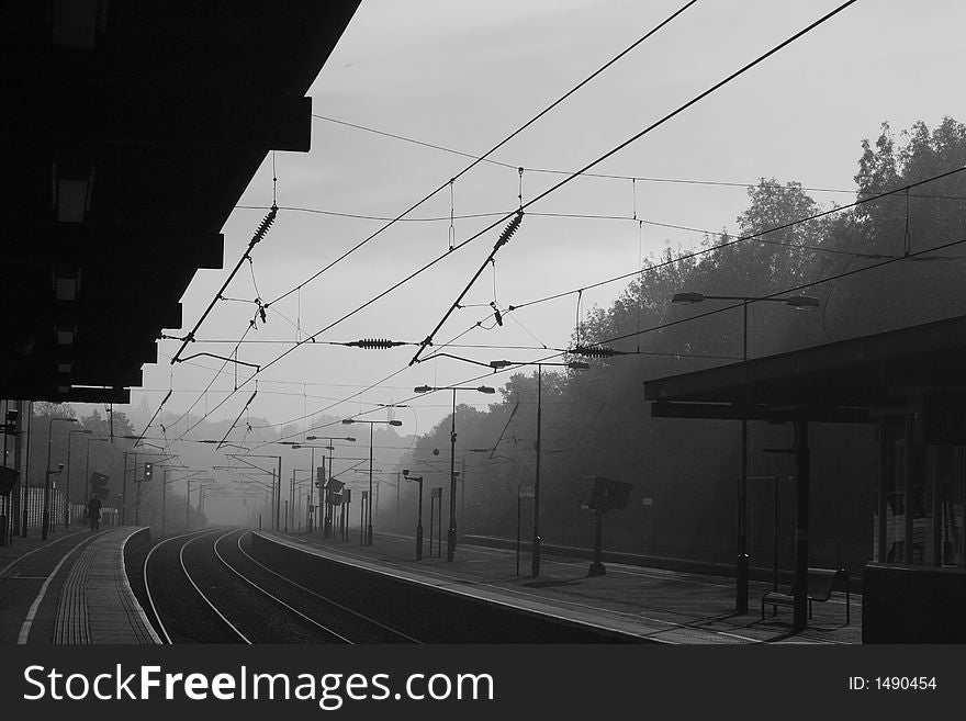 Looking down a railway train station on a misty morning. Looking down a railway train station on a misty morning