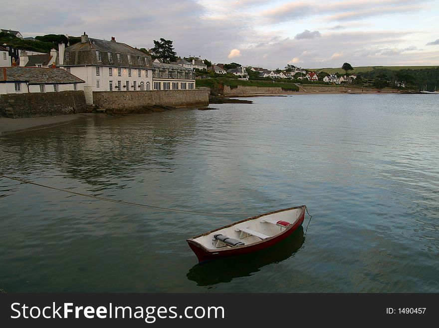 Rowing boat moored in harbour. Rowing boat moored in harbour.