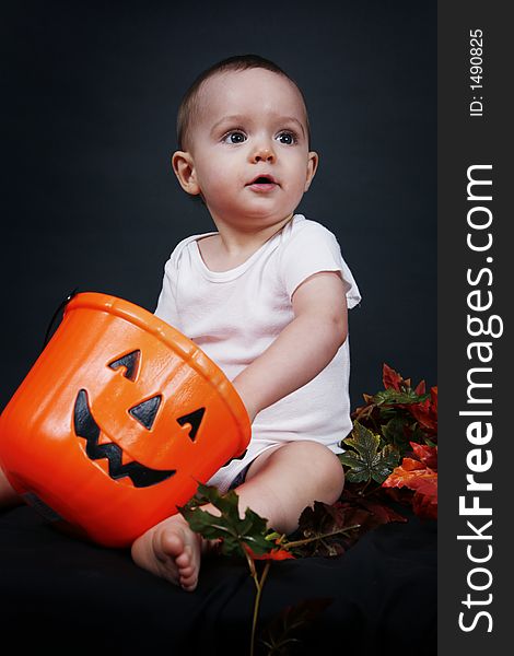 Beautiful baby boy poses on a black background