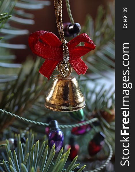Old gold bell on christmas tree twig