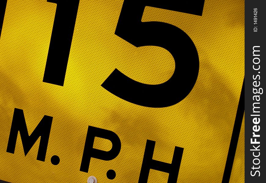 Sectional shot of road sign stating speed limit.