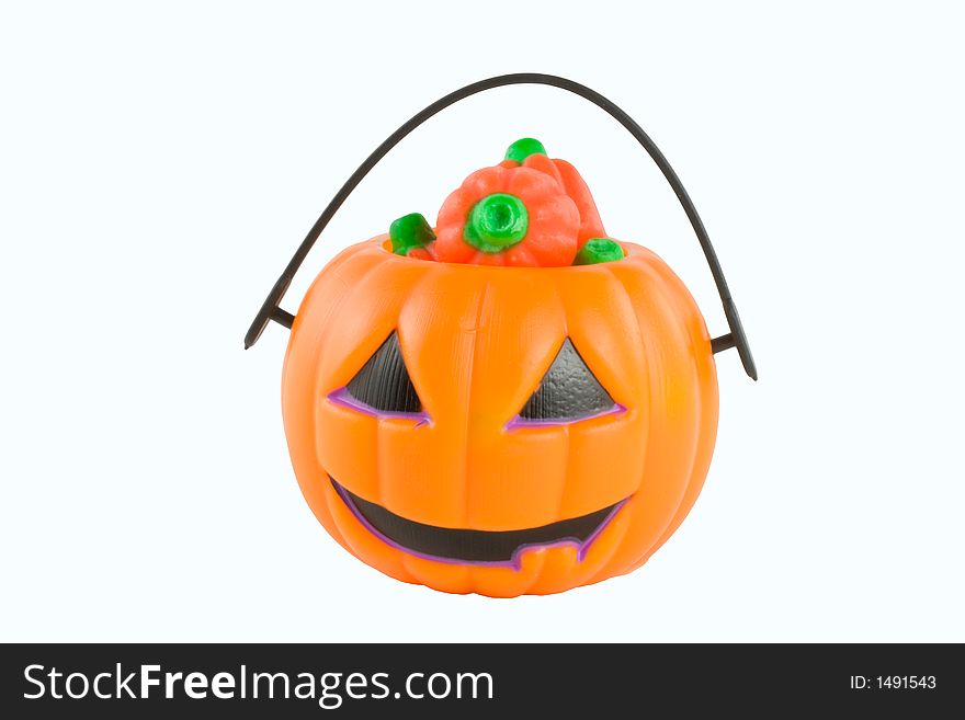 Small Halloween trick or treating bucket filled with candy. Small Halloween trick or treating bucket filled with candy