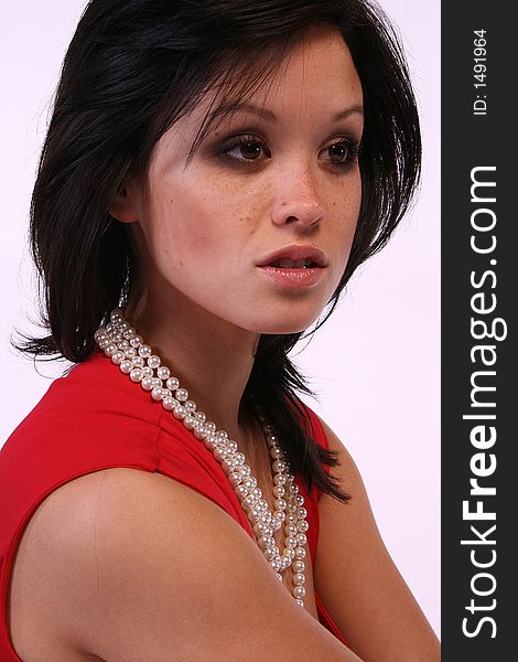 Asian model with pearls and a red dress.