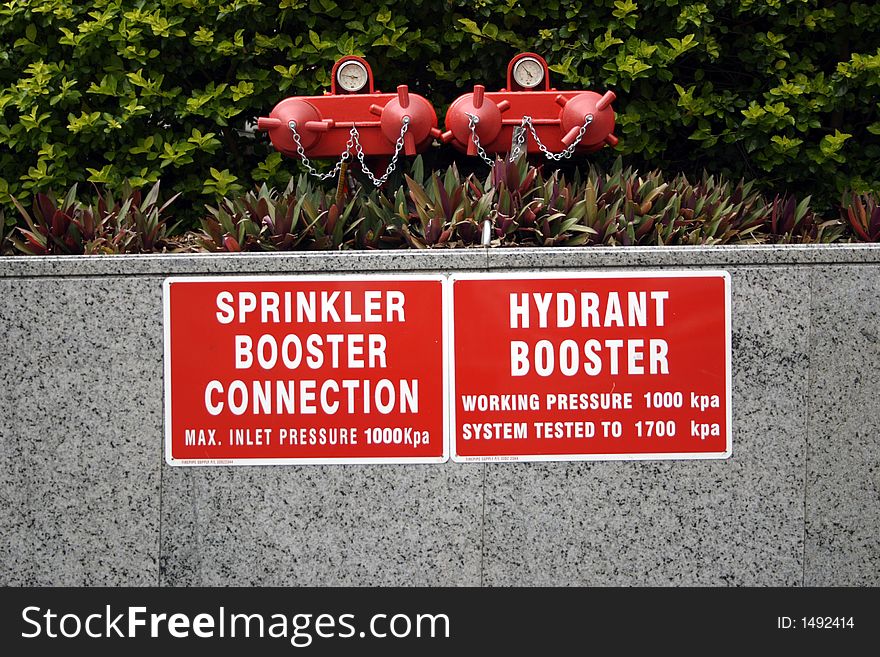Booster and hydrant point on a new building with signs. Booster and hydrant point on a new building with signs