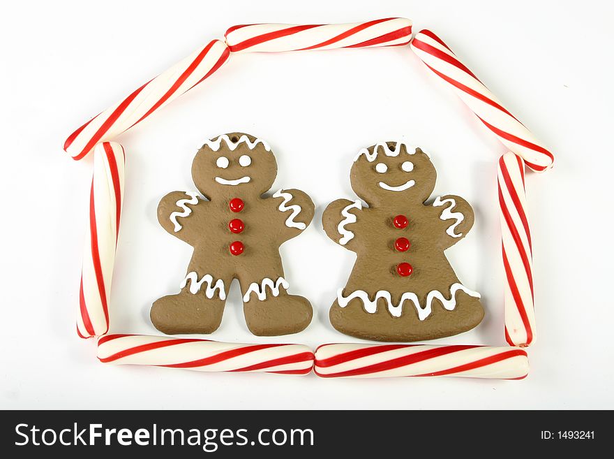 Two traditional gingerbread people, one male and one female isolated on white space. Two traditional gingerbread people, one male and one female isolated on white space