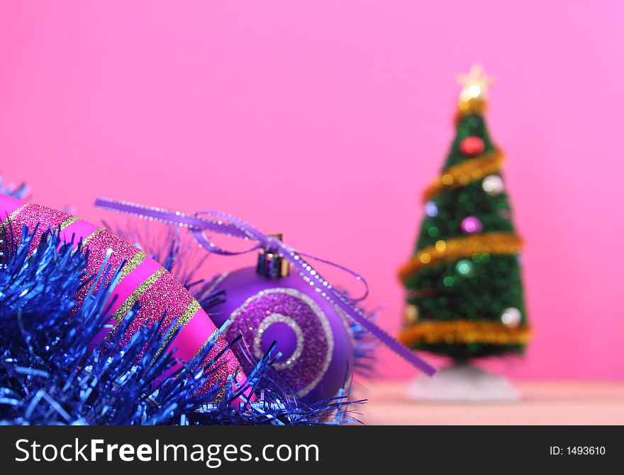 Christmas Ornaments and Christmas Tree on Pink Background, Shallow DOF. Christmas Ornaments and Christmas Tree on Pink Background, Shallow DOF