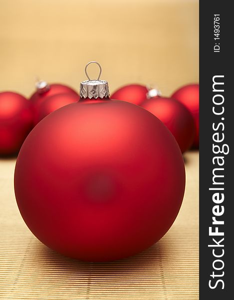 Red christmas decoration on gold background.