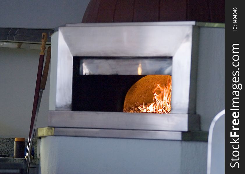 Burning firewood in pizza oven