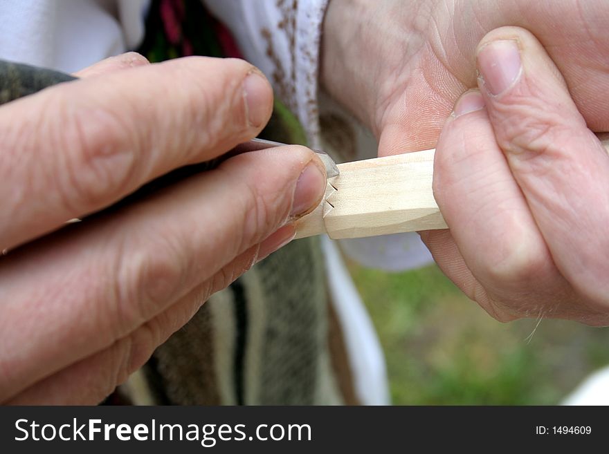 Craftsman using tools for making a spoon