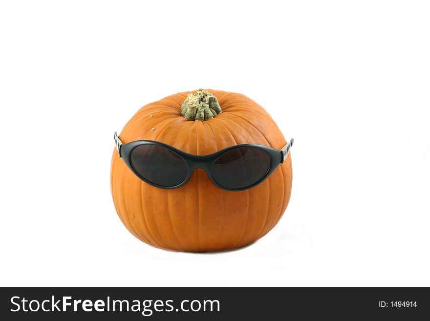 Whole large pumpkin dressed  with his  dark glasses. Whole large pumpkin dressed  with his  dark glasses