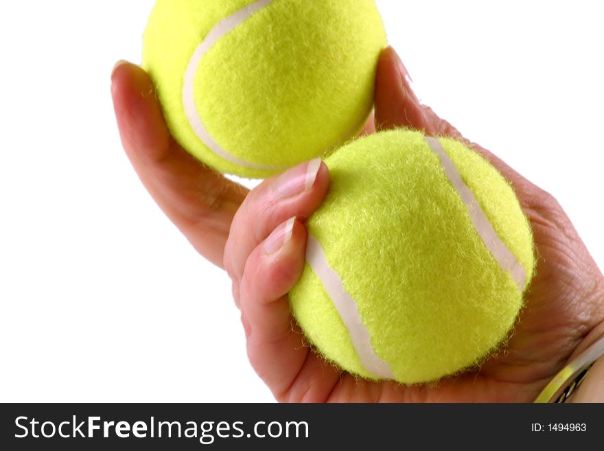 Two tennis balls being held by a tennis player