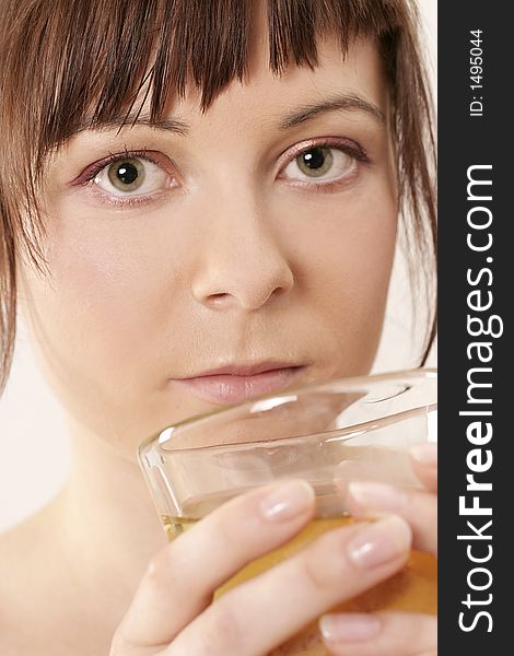 Young girl, woman drinking from a glass -close up. Young girl, woman drinking from a glass -close up