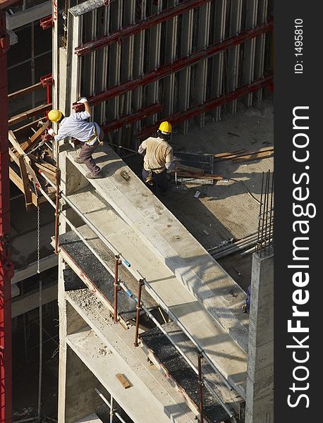 Construction workers on the job at a high-rise apartment project. Construction workers on the job at a high-rise apartment project