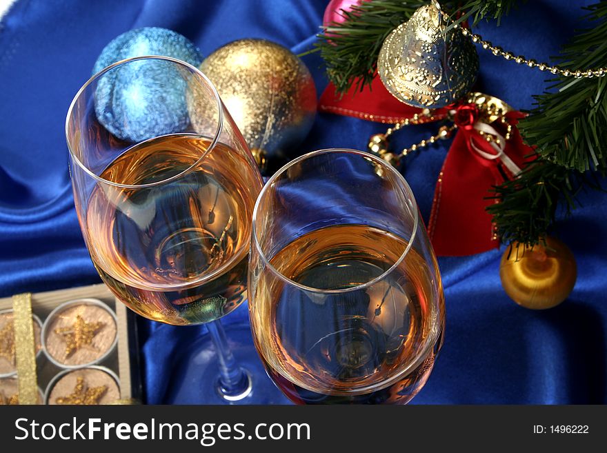 Glass of white wine on a beautiful christmas background with a New Year tree