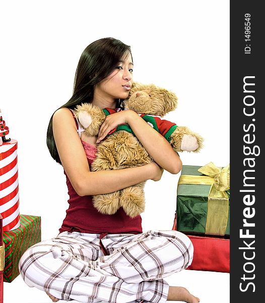 girl sitting with a teddy bear and presents on a white background. girl sitting with a teddy bear and presents on a white background.