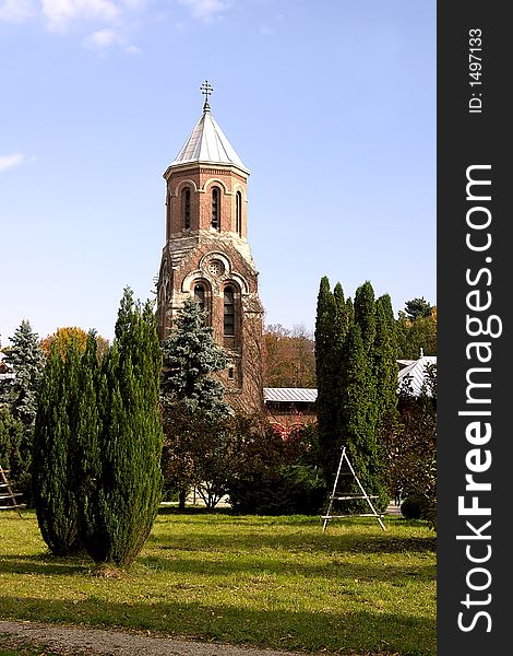 Brick church bell tower in Curtea de Arges Monastery park - Romania